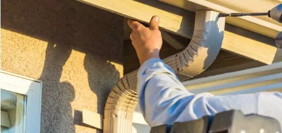 Schneider Construction builder adjusting gutters on a home in Central Illinois