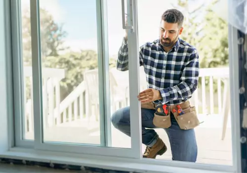 A man installing new sliding Doors for a home in Peoria IL