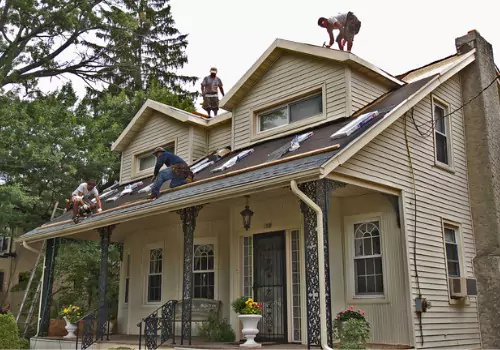 Roofer are seen at a job site. Schneider Construction is one of the best roofing companies in Peoria IL.